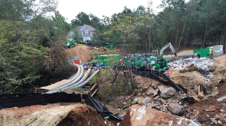 Contractors for DeKalb County were repairing large sewer pipes near Snapfinger Creek on Monday, Oct. 2, 2017. The pipes burst in August, spilling 6.4 million gallons of sewage. MARK NIESSE / MARK.NIESSE@AJC.COM