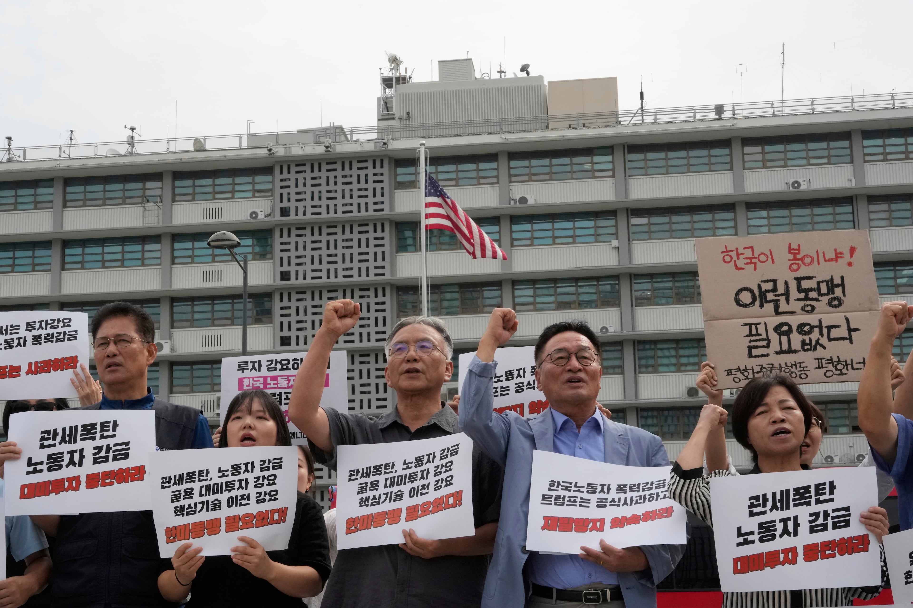 Protesters stage a rally against the detention of South Korean workers during an immigration raid in Georgia, near the U.S. Embassy in Seoul, South Korea, Tuesday, Sept. 9, 2025. The signs read "A tariff bomb and workers confinement." (Ahn Young-joon/AP)