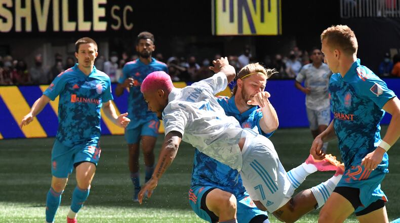 May 29, 2021 Atlanta - Atlanta United forward Josef Martinez (7) collides with Nashville SC defender Walker Zimmerman (25) as he works with the ball during the second half in a MLS soccer match at Mercedes-Benz Stadium in Atlanta on Saturday, May 29, 2021. The game ended with 2-2. (Hyosub Shin / Hyosub.Shin@ajc.com)