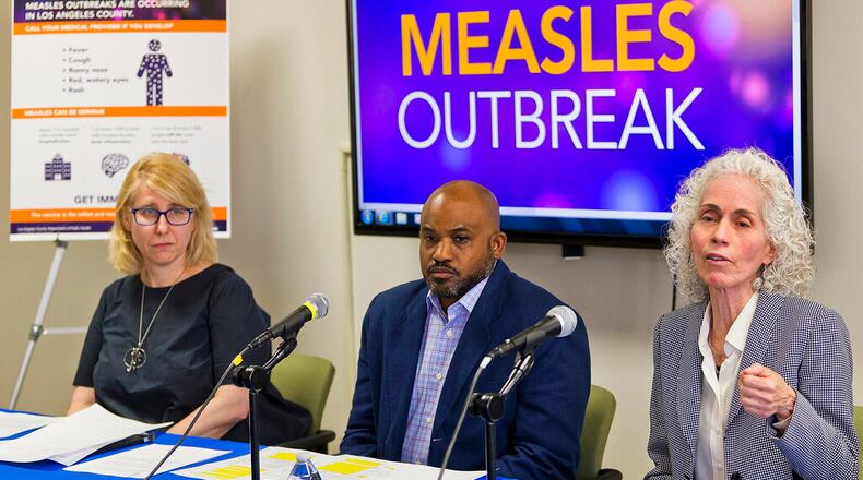 Los Angeles County Department of Public Health experts, from left, Dr. Sharon Balter, Director of Acute Communicable Disease Control, Muntu Davis, Health Officer, and Dr. Barbara Ferrer, Director, answer questions regarding the measles response and the quarantine orders in Los Angeles Friday, April 26, 2019. More than 900 students and staff members at two Los Angeles universities have been quarantined on campus or sent home in one of the most sweeping efforts to contain the spread of measles in the U.S. (AP Photo/Damian Dovarganes)