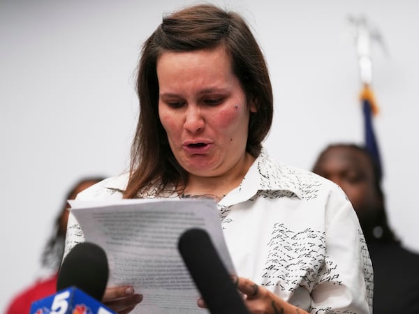 One of sexual assault survivor Kate-Lynn (first name only), cries as she talks to media during a news conference in Chicago, Wednesday, July 16, 2025. (AP Photo/Nam Y. Huh)