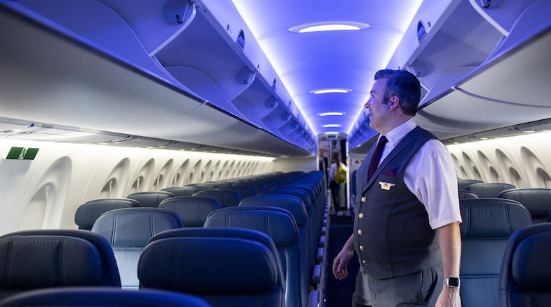 Flight attendant Jonathan Herseth looks at the interior of a new Delta Air Lines A220. A $2 trillion federal relief package is intended to provide some relief for airlines and workers hurt by the COVID-19 pandemic. (Nicole Neri/Minneapolis Star Tribune/TNS)