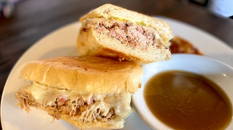 The Cuban sandwich at Rico’s World Kitchen trades the traditional roasted pork and ham combo for marinated and smoked chicken. Angela Hansberger for The Atlanta Journal-Constitution