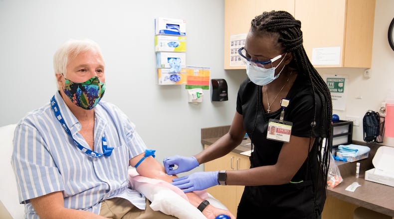 Jack Krost participates in Phase 3 of the COVID-19 vaccine trial at Emory University’s Hope Clinic. He’s being treated by Juton Winston, clinical research coordinator at the Hope Clinic. PROVIDED BY EMORY UNIVERSITY