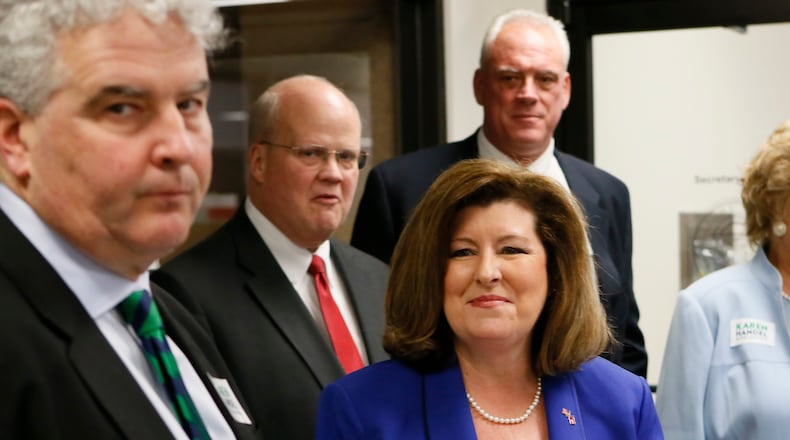 Karen Handel (center), with her husband, Steve Handel (left) as she waits to qualify for the Sixth District congressional seat. Bob Andres, bandres@ajc.com