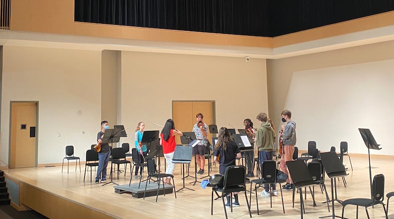Renowned musician Helen Kim (in red) leads a group of high school students through an intensive strings session at KSU's summer program.