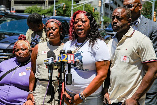 Arnitra Hollman (center), Johnny Hollman’s daughter, talks about his death in 2024. (Ziyu Julian Zhu/AJC)