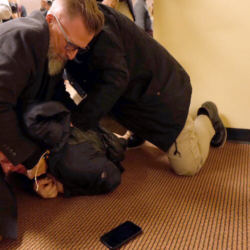 A man is tackled to the ground after spraying an unknown substance on U.S. Rep. Ilhan Omar, D-Minn., during a town hall on Tuesday, Jan. 27, 2026, in Minneapolis. (Richard Tsong-Taatarii/Star Tribune via AP)