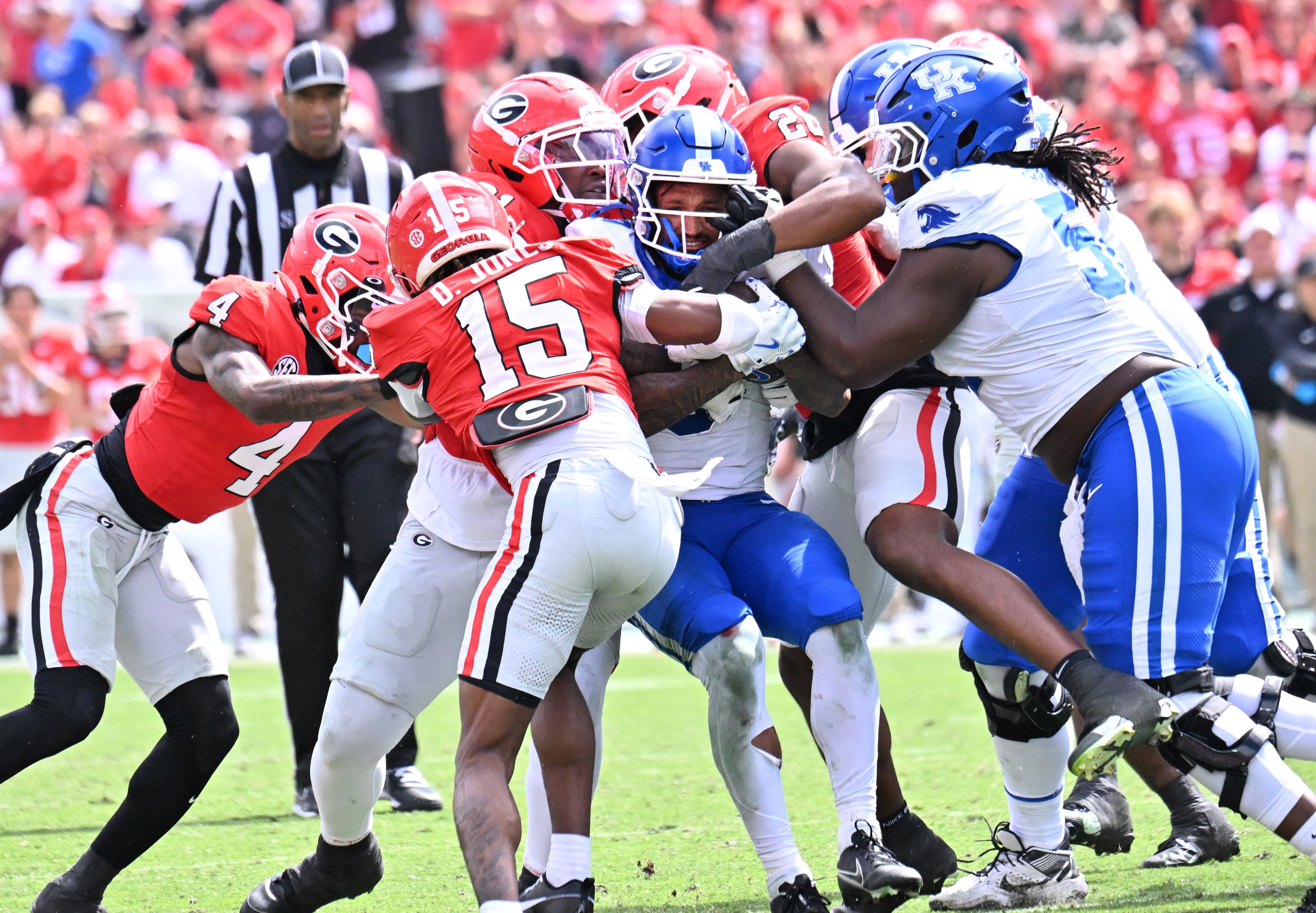 Kentucky running back Seth McGowan (center) is stopped by Georgia defensive players during the second half in a NCAA college football game at Sanford Stadium, Saturday, October 4, 2025, in Athens. Georgia won 35 -14 over Kentucky. (Hyosub Shin / AJC)