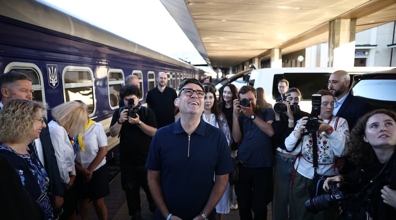 Britain's prime minister Andy Burnham, centre, smiles upon his arrival by train, in Kyiv, Monday, Aug. 24, 2026. (Henry Nicholls/Pool Photo via AP)