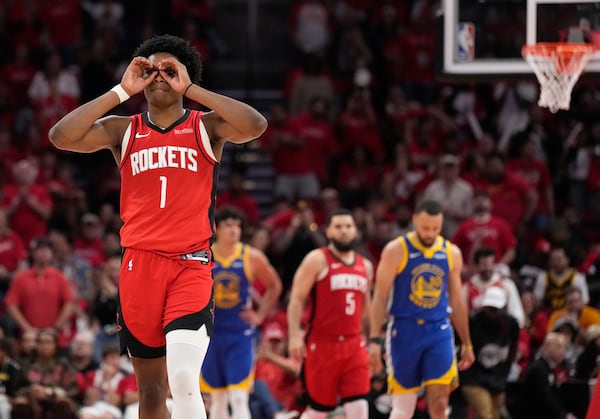 Houston Rockets guard Amen Thompson (1) reacts after dunking the ball against the Golden State Warriors during the second half of Game 2 of an NBA basketball first-round playoff series against the Houston Rockets in Houston, Wednesday, April 23, 2025. (AP Photo/Karen Warren)