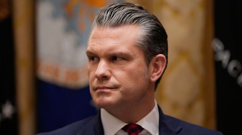 Defense Secretary Pete Hegseth listens as President Donald Trump speaks during a Cabinet meeting at the White House, Tuesday, Dec. 2, 2025, in Washington. (AP Photo/Julia Demaree Nikhinson)