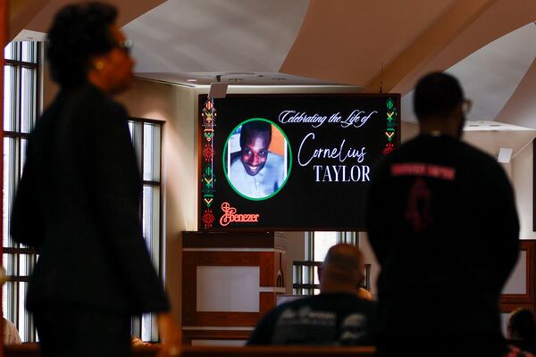 A remembrance for Cornelius Taylor is displayed on a screen inside the Ebenezer Baptist Church ahead of his memorial service on Feb. 3. Taylor, who was experiencing homelessness, died during an incident involving city workers clearing a homeless encampment Jan. 16. Miguel Martinez/AJC