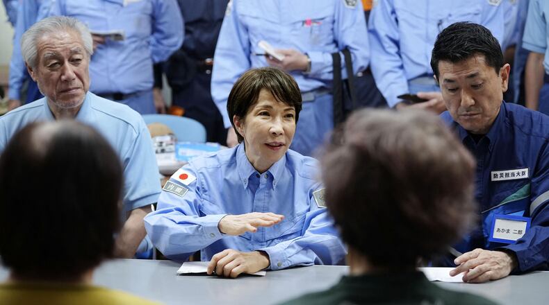 Japan's Prime Minister Sanae Takaichi meets evacuees as she visits an evacuation center in Hikawa, southern Japan, Monday, Aug. 3, 2026. (Japan Pool/Kyodo News via AP)