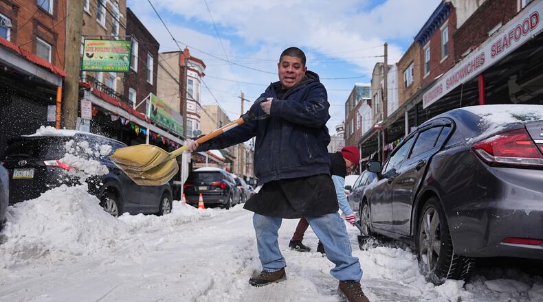 Gilberto Hernandez shovels snow in the aftermath of a winter storm in Philadelphia, Monday, Jan. 26, 2026. (AP Photo/Matt Rourke)