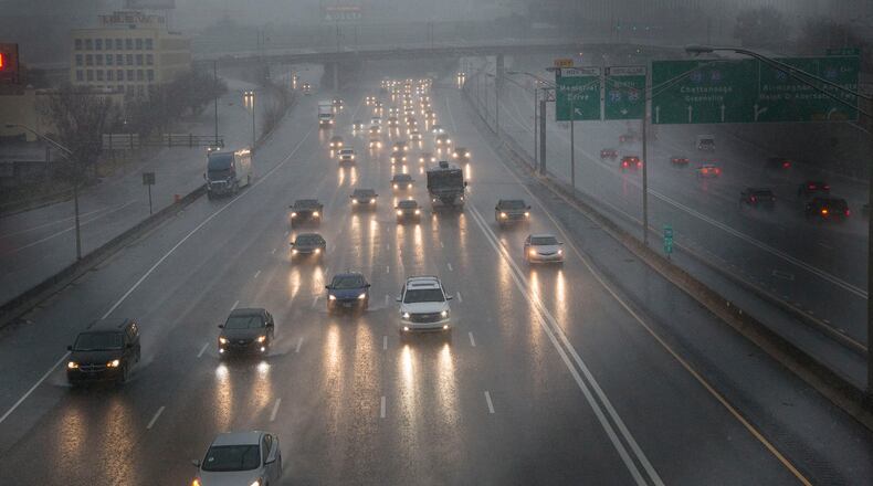 Traffic makes its way through Atlanta as rain showers blanket the area on Friday morning. The Georgia Department of Transportation urged motorists to be cautious. (Photo by Phil Skinner)