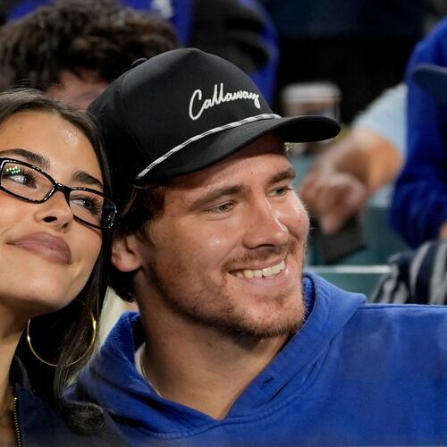 FILE - Los Angeles Chargers quarterback Justin Herbert and girlfriend Madison Beer watch the Toronto Blue Jays and the Los Angeles Dodgers compete during the seventh inning in Game 3 of baseball's World Series, Monday, Oct. 27, 2025, in Los Angeles. (AP Photo/Ashley Landis, File)