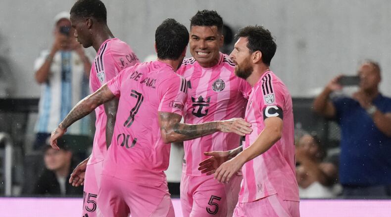 Inter Miami midfielder Casemiro (5) celebrates with midfielder Rodrigo De Paul (7) and forward Leo Messi (10) after scoring a goal during the first half of an MLS soccer match against Atlanta United, Saturday, Sept. 5, 2026, in Miami. (AP Photo/Lynne Sladky)