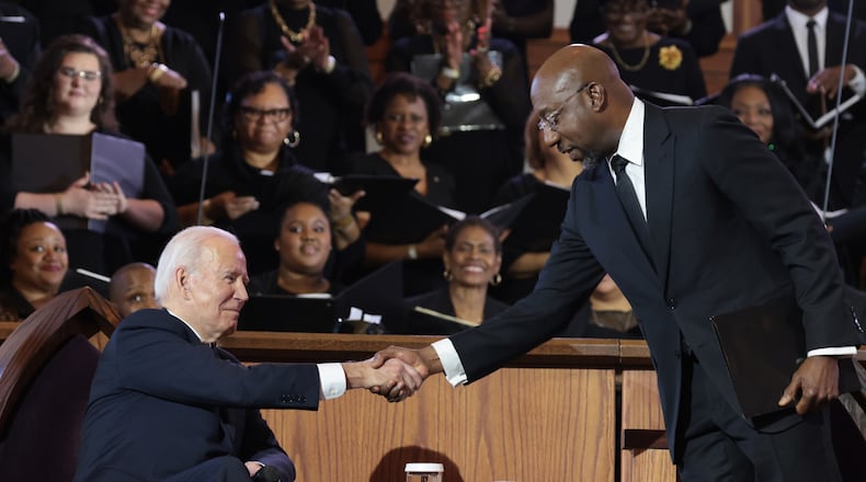 President Joe Biden shakes hands with Democratic U.S. Sen. Raphael Warnock before delivering remarks at Ebenezer Baptist Church in Atlanta, where Warnock is the senior pastor. (Oliver Contreras/The New York Times)