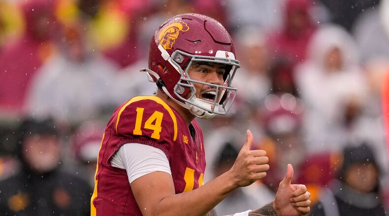 Southern California quarterback Jayden Maiava gestures to teammates during the first half of an NCAA college football game against Iowa, Saturday, Nov. 15, 2025, in Los Angeles. (AP Photo/Mark J. Terrill)