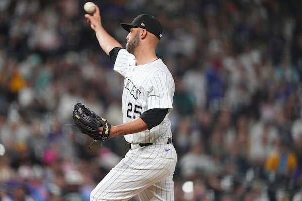 Normally a catcher, Colorado Rockies' Jacob Stallings works as a relief pitcher against the San Diego Padres in the eighth inning of a baseball game Saturday, May 10, 2025, in Denver. (AP Photo/David Zalubowski)