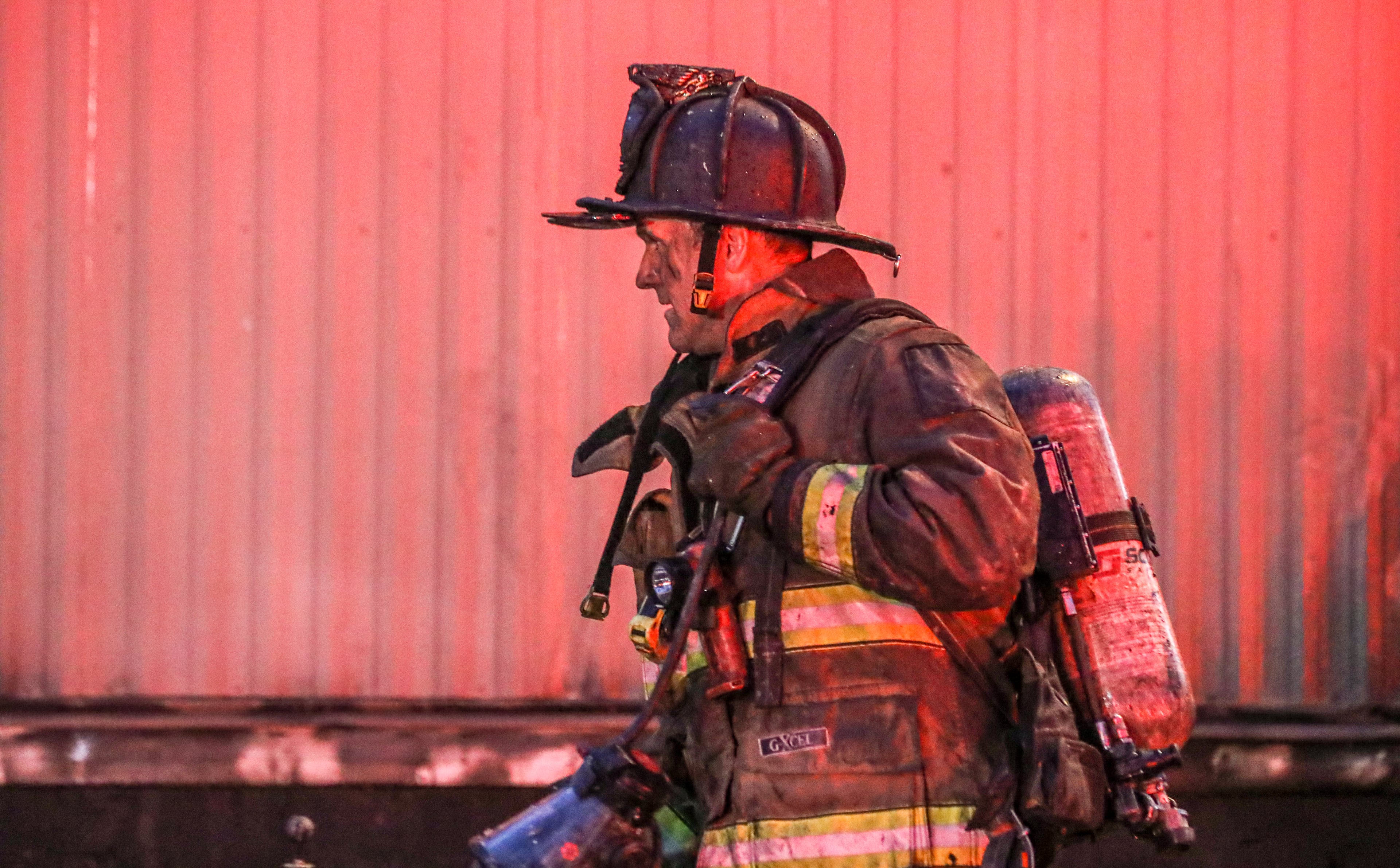 Chris Moss enters the fire zone of a mobile home fire in 2022. (John Spink/AJC file)
