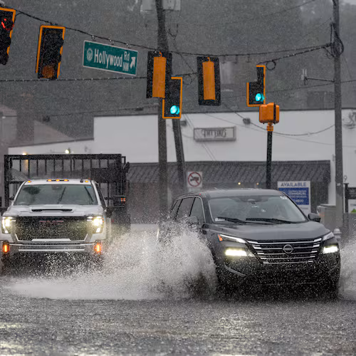 Motorists drive through a flooded street in northwest Atlanta on Saturday, Sept. 12, 2026. (Ben Hendren for the AJC)