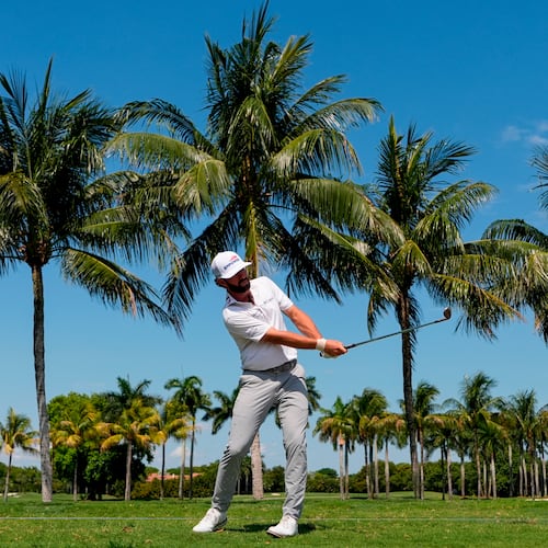 Cameron Young hits along the cart path on the first fairway during the first round of the Cadillac Championship PGA golf tournament Thursday, April 30, 2026, in Doral, Fla. (AP Photo/David J. Phillip)