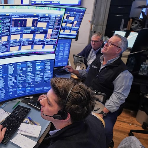 A trio of traders work on the floor of the New York Stock Exchange, Wednesday, June 3, 2026. (AP Photo/Richard Drew)