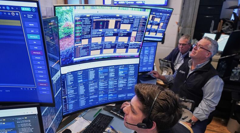 A trio of traders work on the floor of the New York Stock Exchange, Wednesday, June 3, 2026. (AP Photo/Richard Drew)