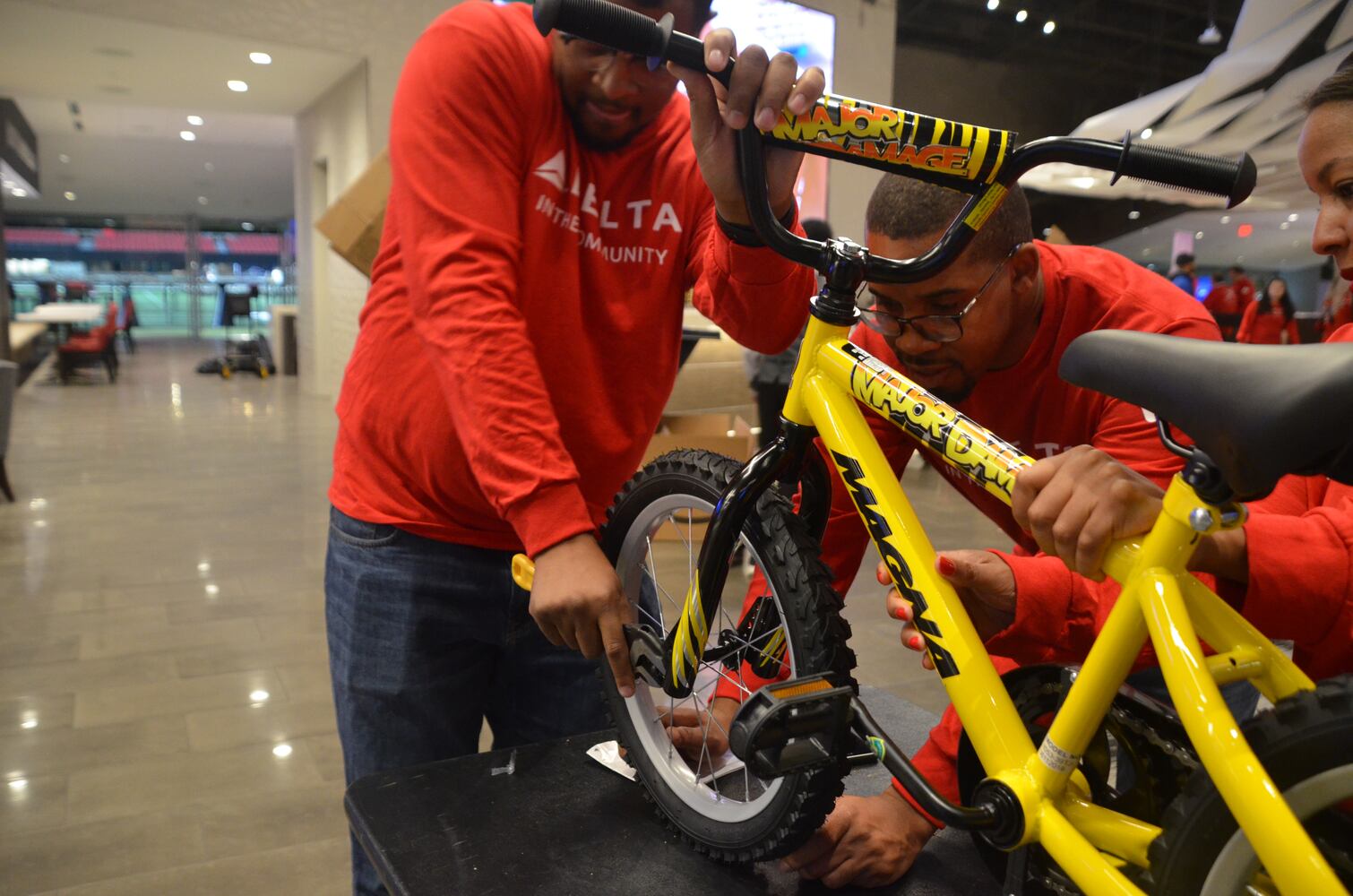 Delta volunteers assemble 100 bicycles to donate to kids