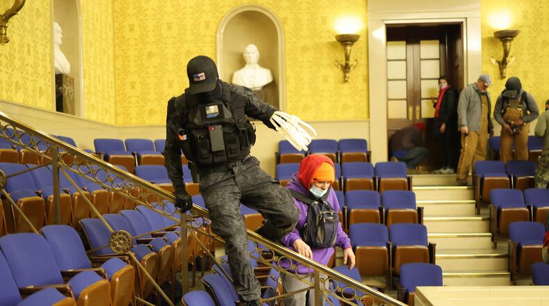 Eric Gavelek Munchel, aka "Zip-tie guy," is being held as he awaits trial for his alleged role in the Jan. 6, 2021, attack on the U.S. Capitol. His mother, Lisa Marie Eisenhart, also arrested in connection with the incident, is complaining about the restrictive conditions in jail. (Win McNamee/Getty Images/TNS)