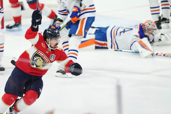 Florida Panthers' Brad Marchand (63) celebrates his goal against Edmonton Oilers goalie Stuart Skinner (74) during the first period in Game 3 of the NHL hockey Stanley Cup finals in Sunrise, Fla., Monday, June 9, 2025. (Nathan Denette/The Canadian Press via AP)
