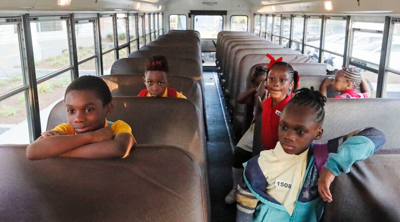 August 12, 2019, 2019 - Atlanta - Students wait their turn to get off their school bus on the first day of school at Tuskegee Airmen Global Academy, where the district is opening a new school building. The cost of the building project was $30.5 million. Bob Andres / robert.andres@ajc.com