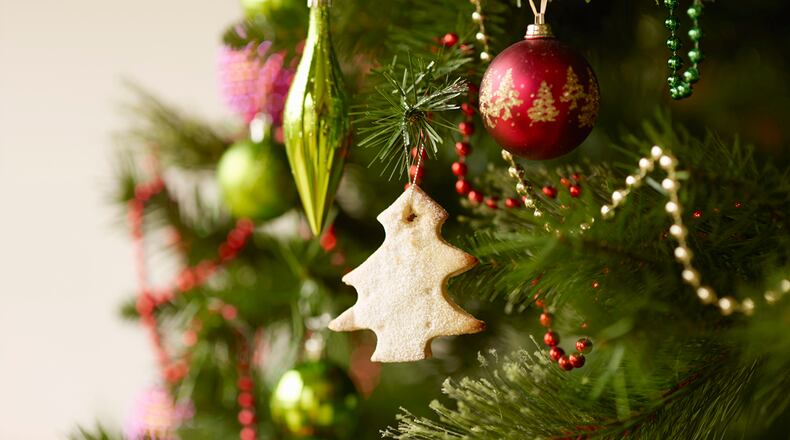 Close up of christmas tree with baubles and christmas biscuits