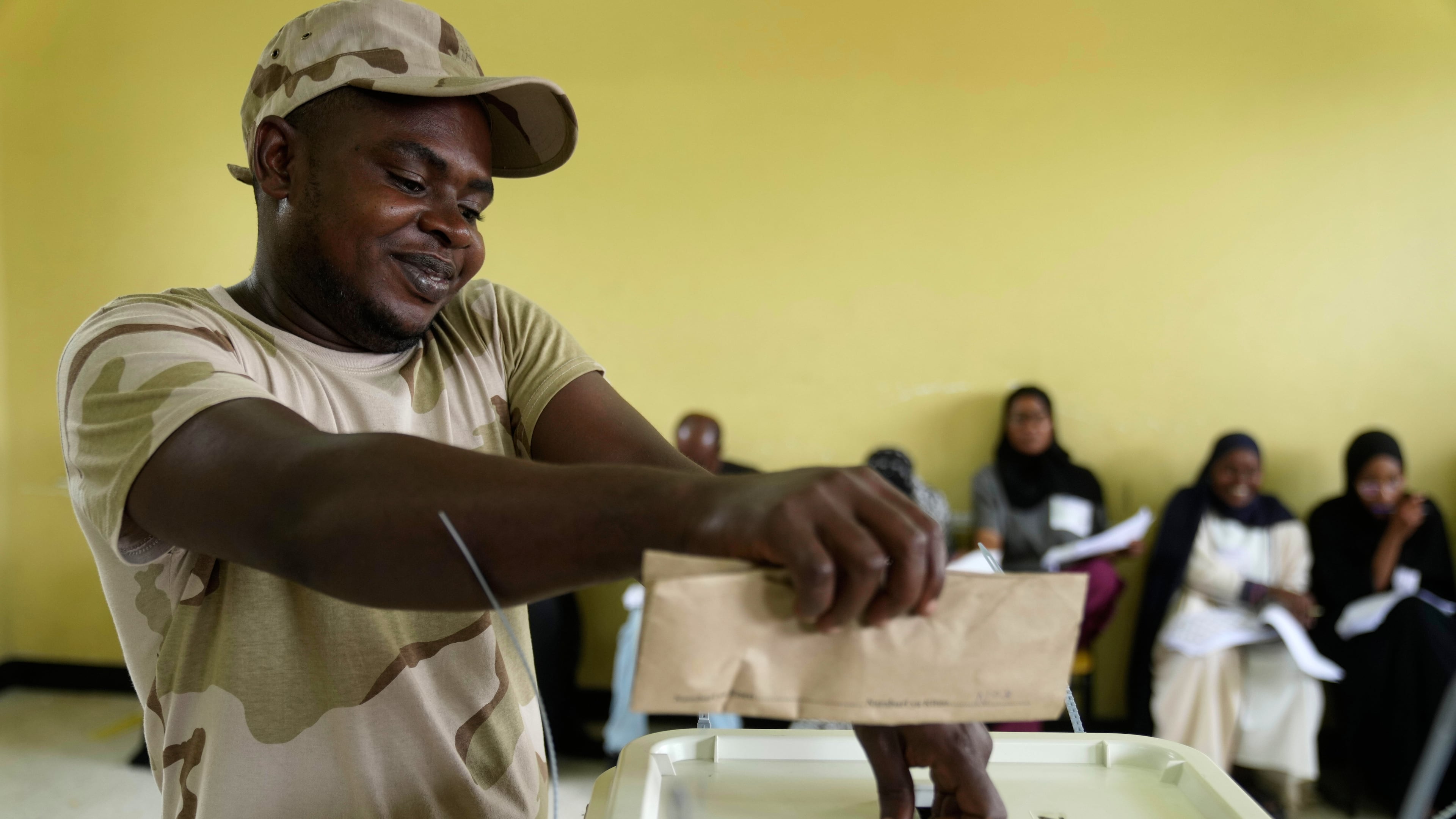 A security personnel member casts his vote during early voting in the general elections at Tumekuja Secondary School polling station in Zanzibar, Tanzania, Tuesday, Oct. 28, 2025. (AP Photo/Brian Inganga)