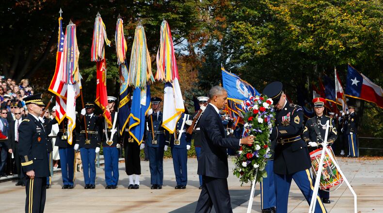 President Barack Obama lays a wreath at the Tomb of the Unknowns, on Veterans Day, Friday, Nov. 11, 2016, at Arlington National Cemetery in Arlington, Va. At left is Maj. Gen. Bradley A. Becker, Commander of the U.S. Army Military District of Washington. (AP Photo/Pablo Martinez Monsivais)