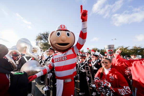 FILE - Brutus, the Ohio State mascot, stands with members of the band outside AT&T Stadium prior to the Cotton Bowl College Football Playoff semifinal game against Texas, Jan. 10, 2025, in Arlington, Texas. (AP Photo/Gareth Patterson, File)