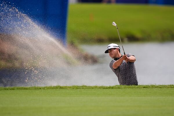 Isaiah Salinda hits out of the sand along the 18th fairway during the first round of the PGA Zurich Classic golf tournament at TPC Louisiana in Avondale, La., Thursday, April 24, 2025. (AP Photo/Gerald Herbert)