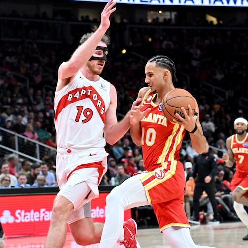 Atlanta Hawks forward Zaccharie Risacher (10) drives against Toronto Raptors center Jakob Poeltl (19) during the second half in the home opener at State Farm Arena, Thursday, October 22, 2025, in Atlanta. Toronto Raptors won 138-118 over Atlanta Hawks. (Hyosub Shin / AJC)
