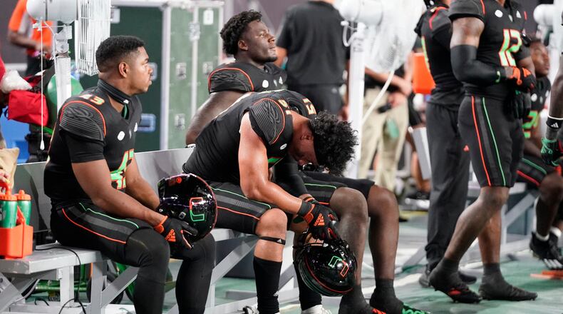 Miami players react in the final seconds of the second half of an NCAA college football game against Georgia Tech, Saturday, Oct. 7, 2023, in Miami Gardens, Fla. (AP Photo/Wilfredo Lee)