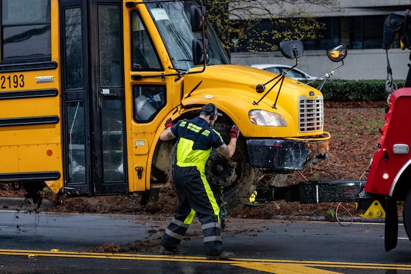 A DeKalb County school bus driver and four students were taken to a hospital for evaluation after a crash Thursday morning. (Ben Hendren for the AJC)
