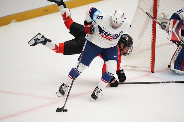 Emma Maltais of Canada, back, challenges United States' Megan Keller during the group A match between United States and Canada at the Women's Ice Hockey Championships in Ceske Budejovice, Czech Republic, Sunday, April 13, 2025. (AP Photo/Petr David Josek)