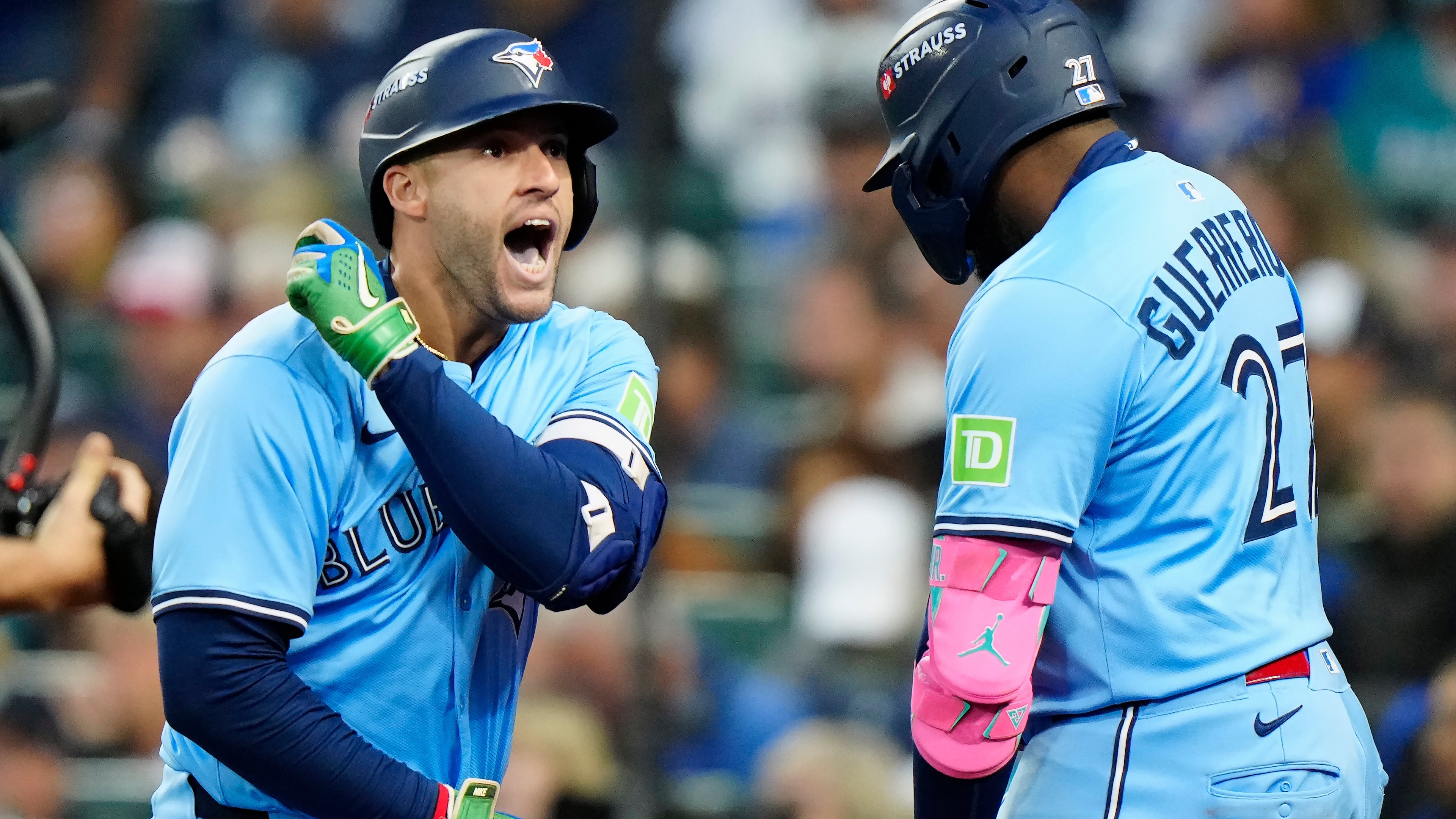 Toronto Blue Jays' George Springer (4) celebrates with Vladimir Guerrero Jr. (27) after hitting a solo home run against the Seattle Mariners during fourth inning Game 3 American League Championship Series baseball action in Seattle on Wednesday, Oct. 15, 2025. (Frank Gunn/The Canadian Press via AP)