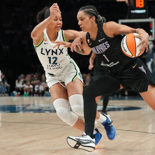 Golden State Valkyries forward Gabby Williams (1) works toward the basket as Minnesota Lynx forward Nia Coffey (12) defends during the second half of a WNBA basketball game Monday, Aug. 24, 2026, in Minneapolis. (AP Photo/Abbie Parr)