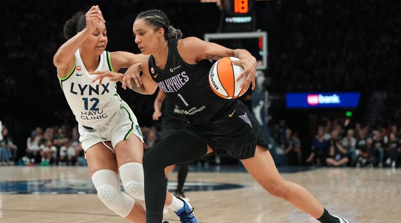 Golden State Valkyries forward Gabby Williams (1) works toward the basket as Minnesota Lynx forward Nia Coffey (12) defends during the second half of a WNBA basketball game Monday, Aug. 24, 2026, in Minneapolis. (AP Photo/Abbie Parr)