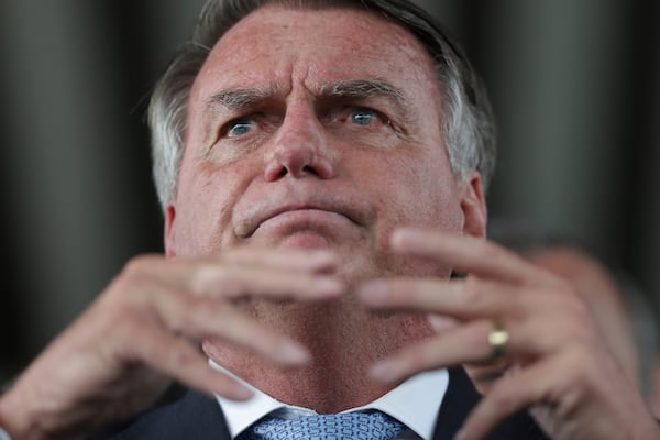 Brazil's former President Jair Bolsonaro speaks to the press at Congress in Brasilia, Brazil, Wednesday, March 26, 2025, after panel of Brazil Supreme Court justices accepted charges against him over an alleged attempt to stay in office after his 2022 election defeat. (AP Photo/Luis Nova)