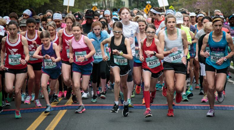 Some of the estimated 2,800 runners push off from the starting line in the annual 2016 Atlanta Women's 5K run/walk on Saturday, March 26, 2016 in Atlanta
