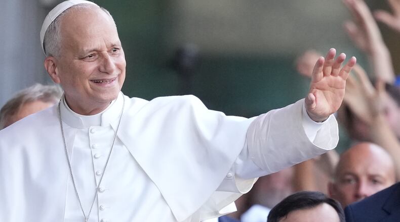Pope Leo XIV greets faithful as he arrives at the 47th Meeting for Friendship Among Peoples in Rimini, Italy, Saturday, Aug. 22, 2026. (AP Photo/Andrew Medichini)