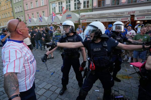 Riot police confront Chelsea fans ahead of the Europa Conference League final soccer match between Real Betis and Chelsea in Wroclaw, Poland, Tuesday, May 27, 2025. (AP Photo/ Czarek Sokolowski)